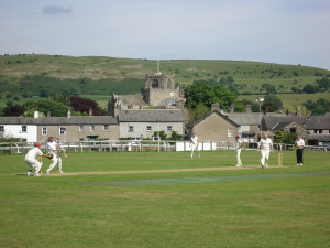 Cricekt at Cartmel, with the Priory in the background 