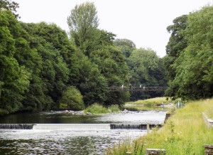 Weir and suspension bridge (look carefully!) on the River Kent